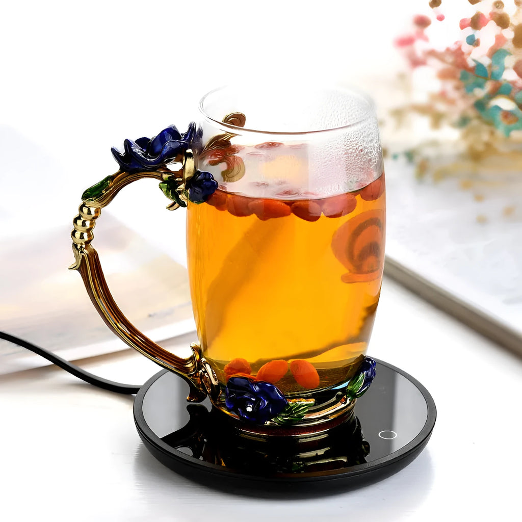 Black coffee cup warmer plate with temperature switch on desk next to mug