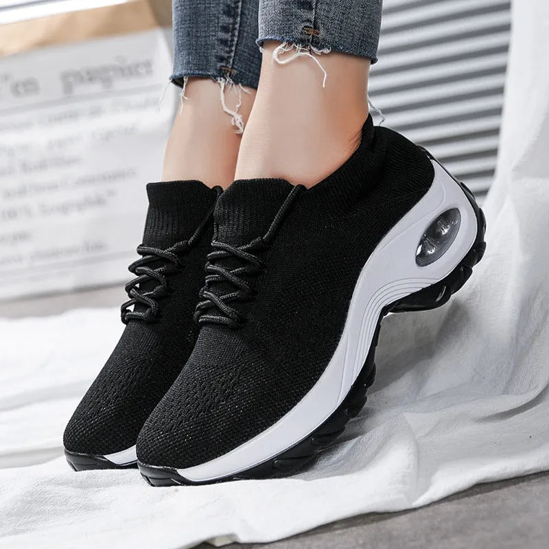 Women's flying knit platform sneakers in black with round toe and waterproof sole
