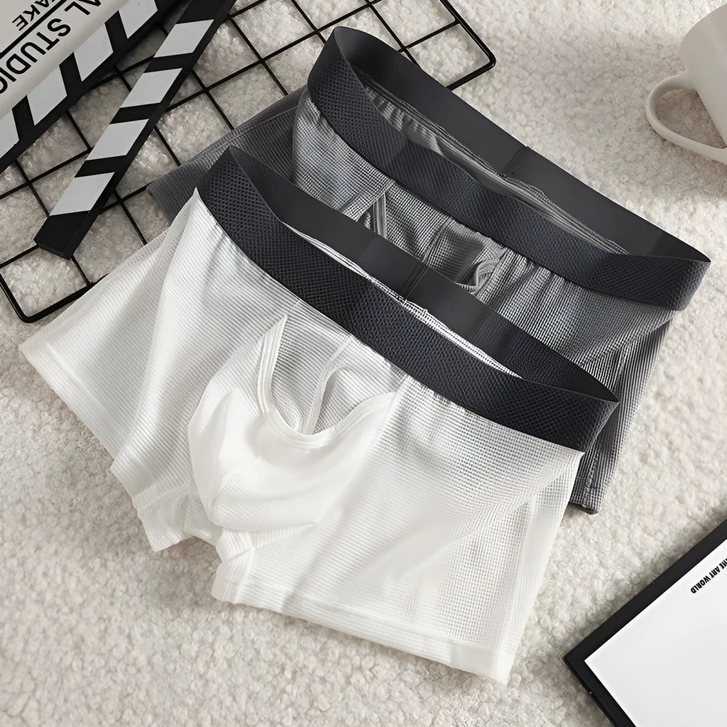 Men's black ice silk boxer shorts with a low waistband and mesh fabric panels.