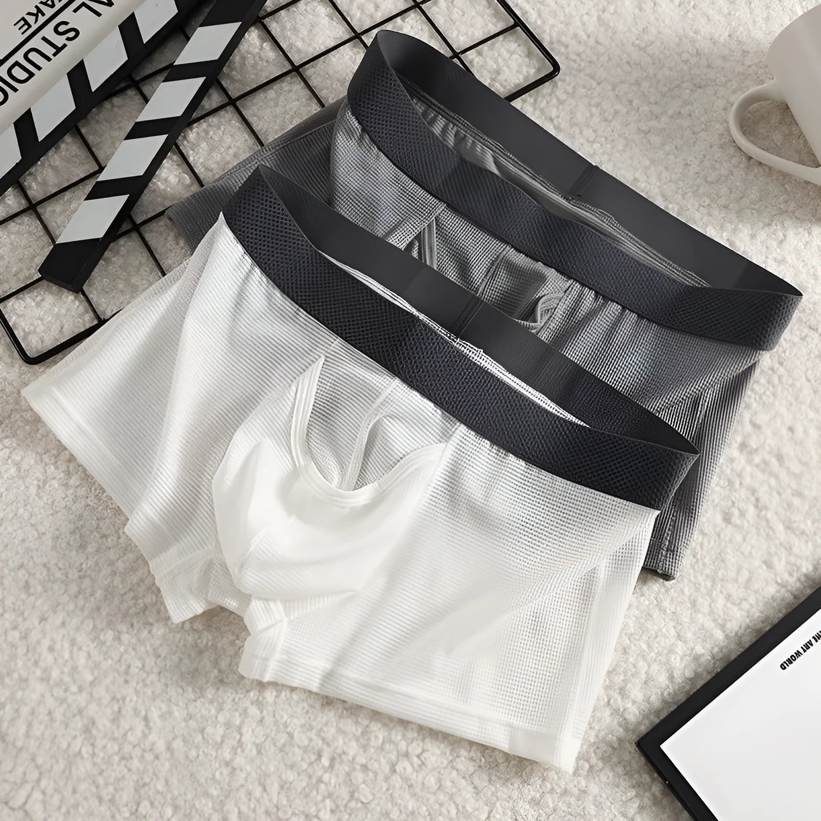 Men's black ice silk boxer shorts with a low waistband and mesh fabric panels.
