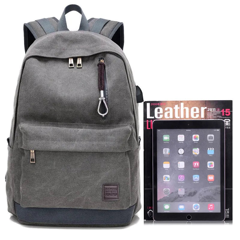 Canvas USB rechargeable backpack in grey showing front pocket and shoulder strap