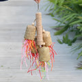 Wood and sisal parrot toy with colourful shredded paper centre for biting and foraging.