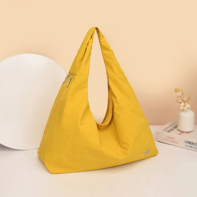 Soft nylon women's underarm bag in a heart shape, shown in black, blue, khaki, and yellow colour options.
