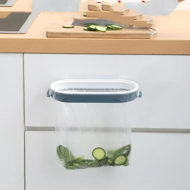 Blue foldable plastic kitchen garbage bag storage rack mounted on a cabinet door.