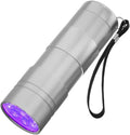 Black aluminium UV flashlight torch for detecting pet urine stains and insects on a dark surface.