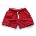 Men's straight-leg beach shorts in polyester, shown in a selection of available colours.