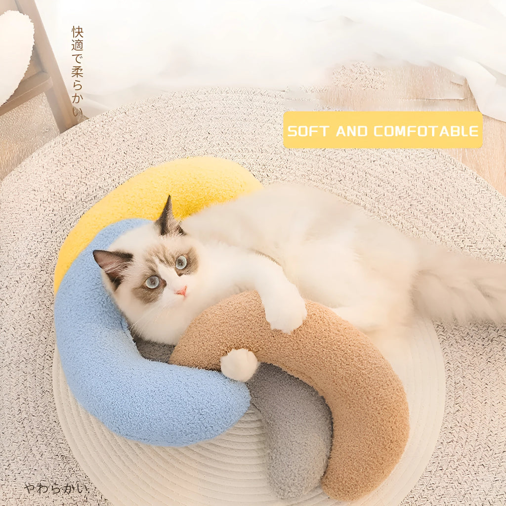 U-shaped blue cat pillow with adjustable collar for cervical support on a sofa