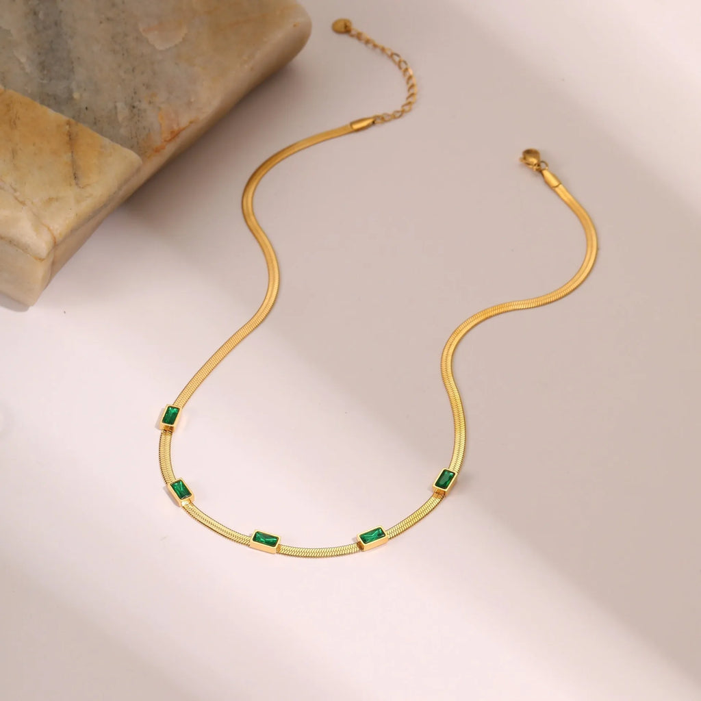 Gold geometric square zircon pendant necklace on a flat stainless steel snake chain.