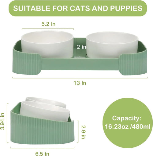Green ceramic raised cat food and water bowls set with tilted stand on a kitchen floor.