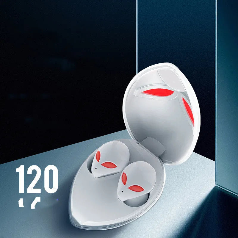 Creative Outer T8 Starman alien-design Bluetooth earbuds with red lighting next to wireless charging case.