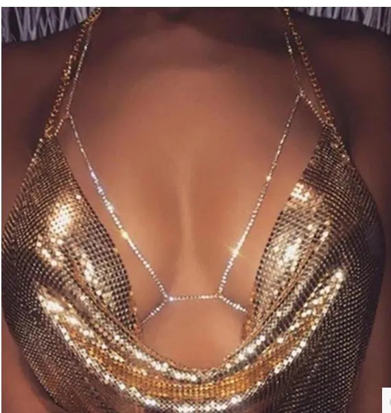 Women's rhinestone metal body chain necklace in gold on a model showing torso wear