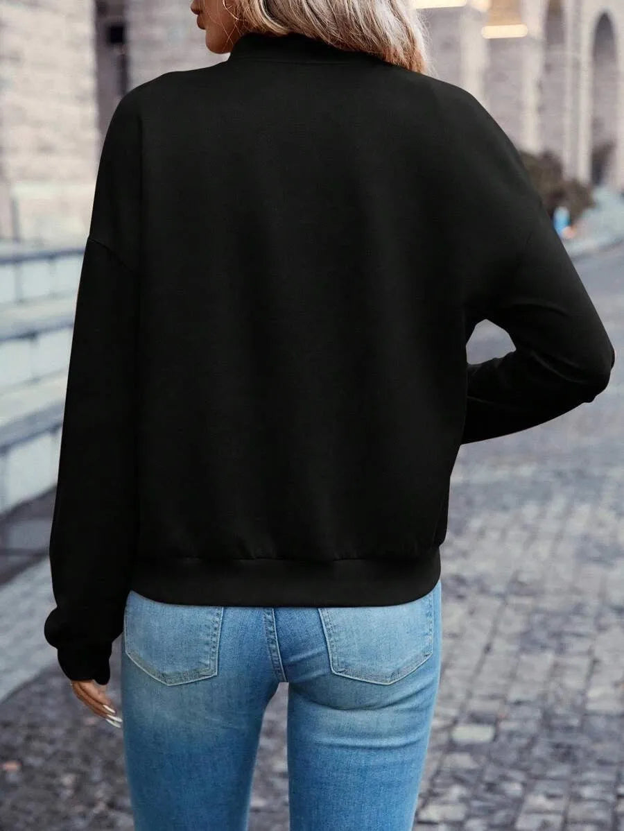 Women's solid black polyester zip jacket with long sleeves and faux pockets