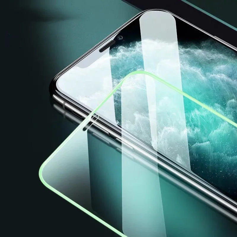 Luminous full cover tempered glass screen protector glowing on an iPhone in a dark setting.