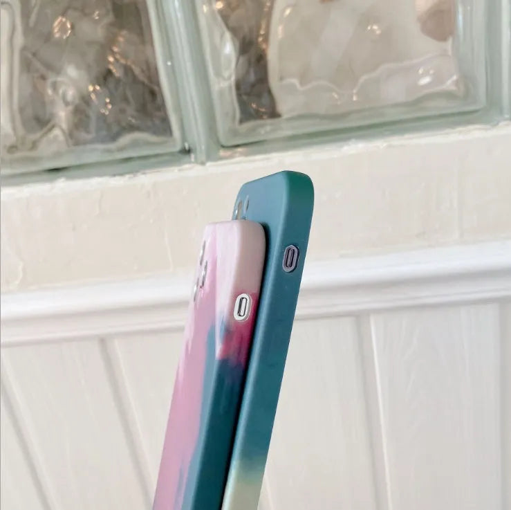 Soft silicone iPhone case with abstract blue gradient geometric design on a phone.