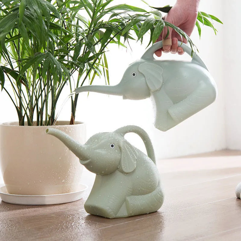 Pink elephant-shaped children's watering can with a long nozzle and bottle-style handle.