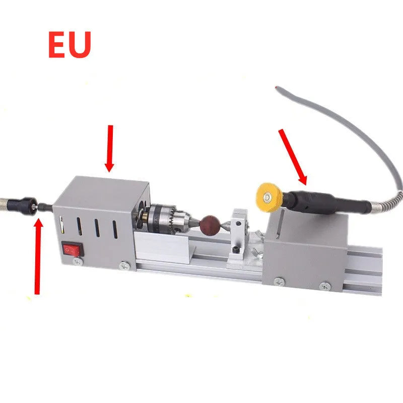 Silver metal mini manual woodworking lathe with carving knives on a workbench.
