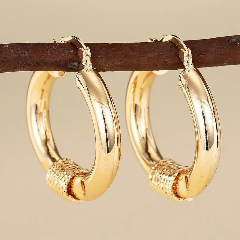 Copper geometric earrings for women in three golden colours with ring and line design elements