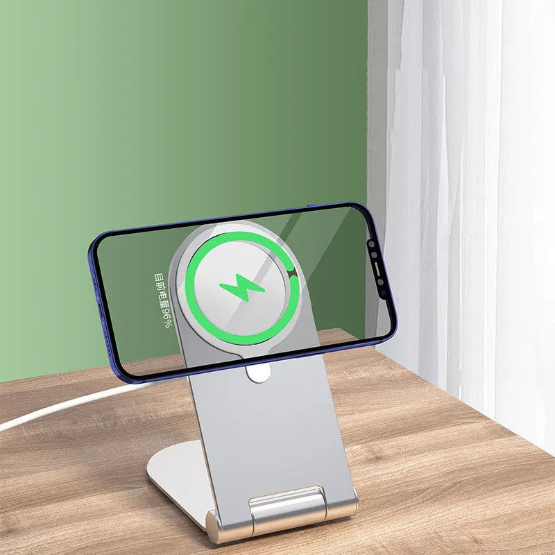 Silver vertical adjustable magnetic phone bracket for iPhone 12 on a flat surface.