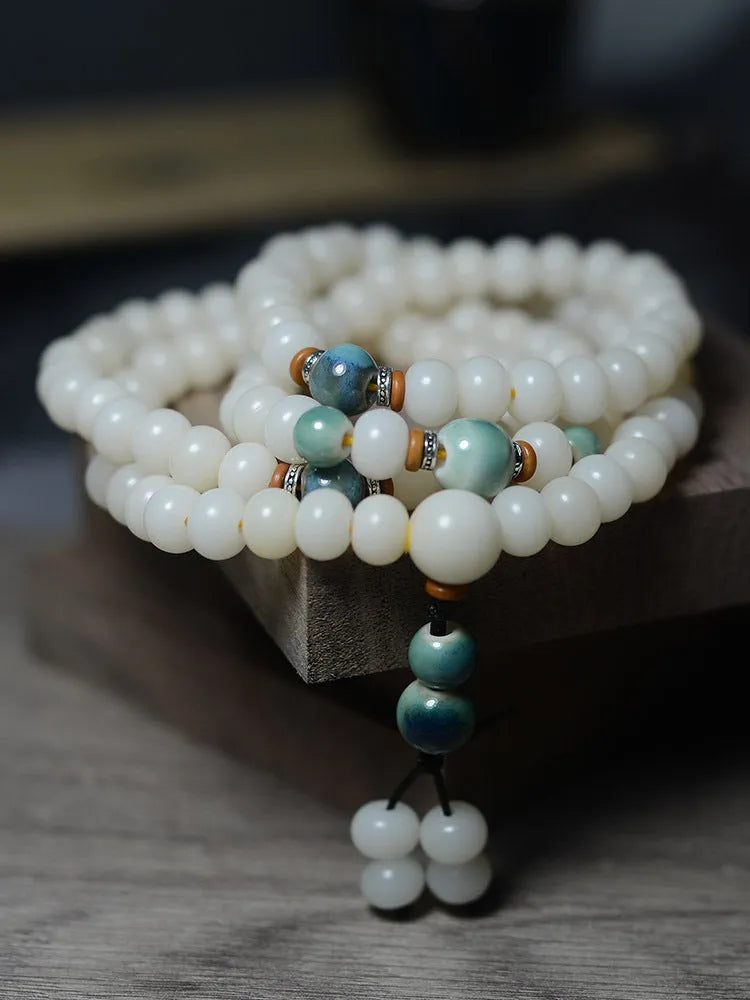 White jade bodhi seed bracelet with 108 flat round beads in 7x9mm and 8x10mm sizes.