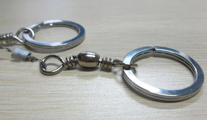 Survival wire saw with stainless steel blade and finger loops, showing 55cm length and pull ring