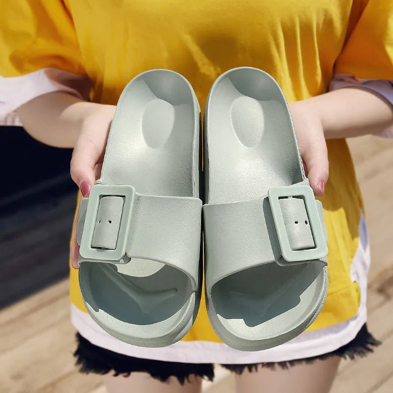 Women's grey blue flip-flop slippers with a buckle strap on a soft EVA sole.
