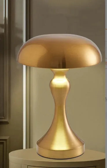 Bronze LED desk lamp with touch control showing three colour temperature settings on wooden desk