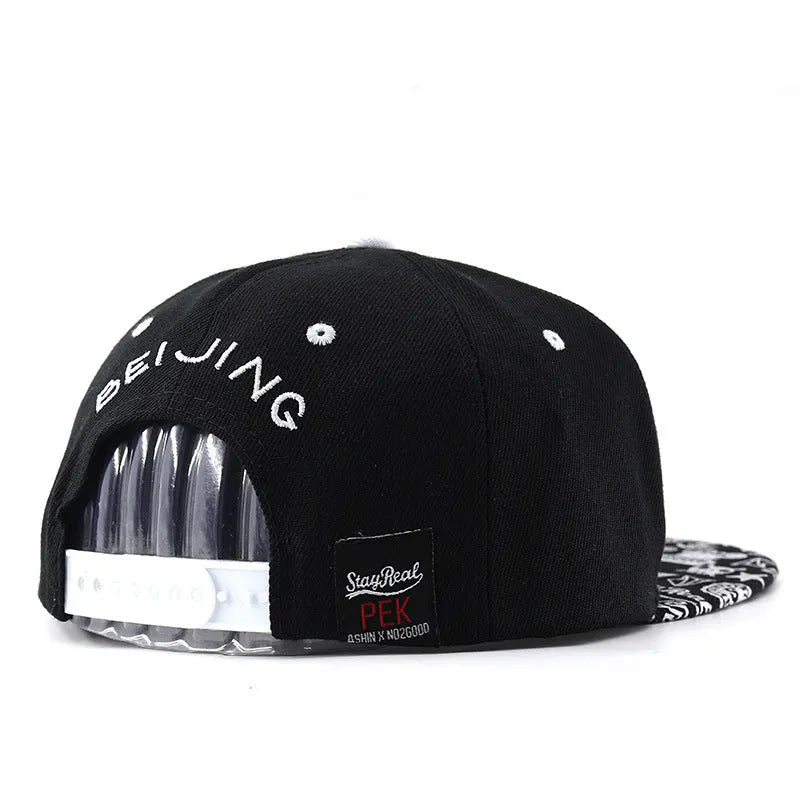 Cotton baseball cap with letter embroidery in black or white colours, showing adjustable strap and dome crown