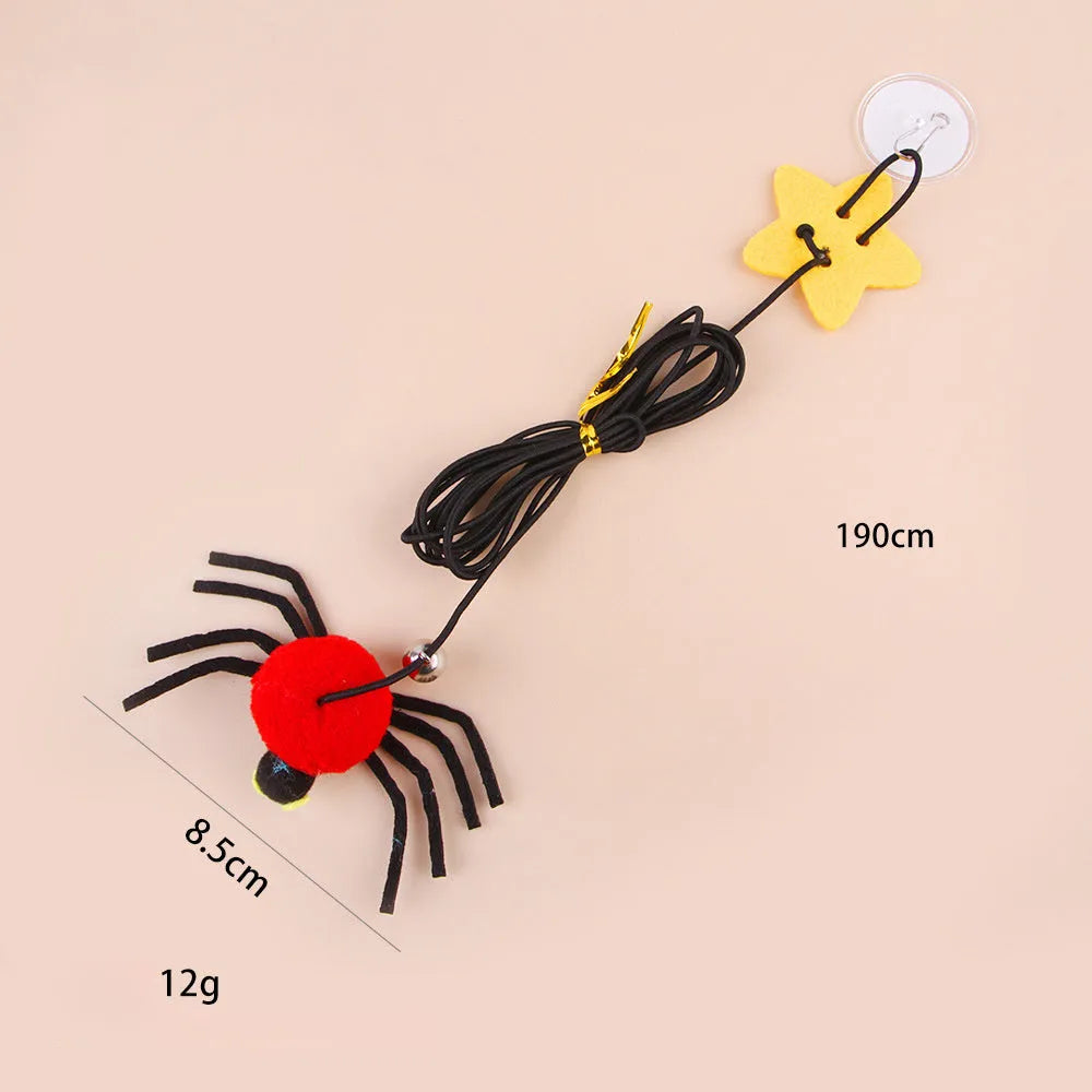 Red and yellow hanging cat toy with elastic rope, feather, bell, and spider elements for door mounting