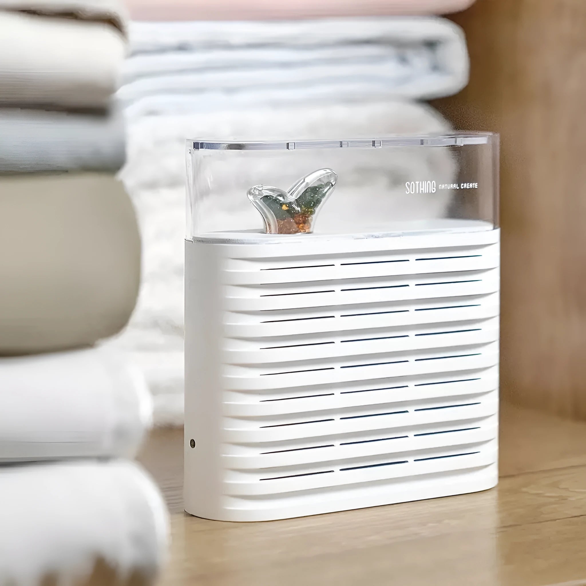 White reusable electric cabinet dehumidifier with transparent top showing orange silica gel crystals.