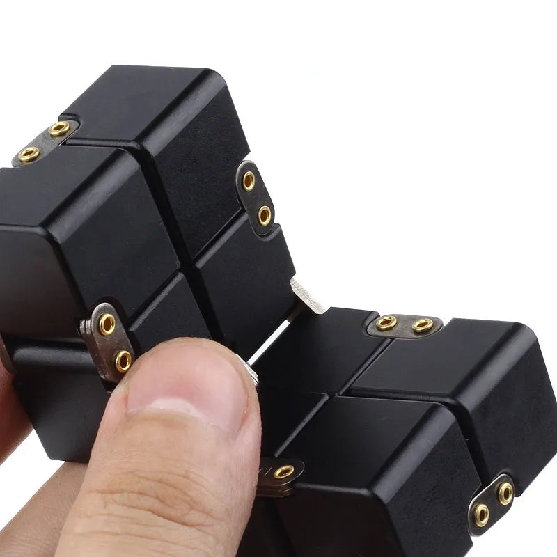 Zinc alloy infinity cube fidget toy in black, measuring 4cm, on a white background