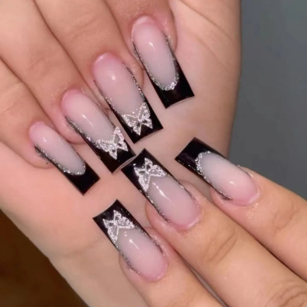French-style false nails with glitter butterfly pattern and flash details on medium-length thin nails