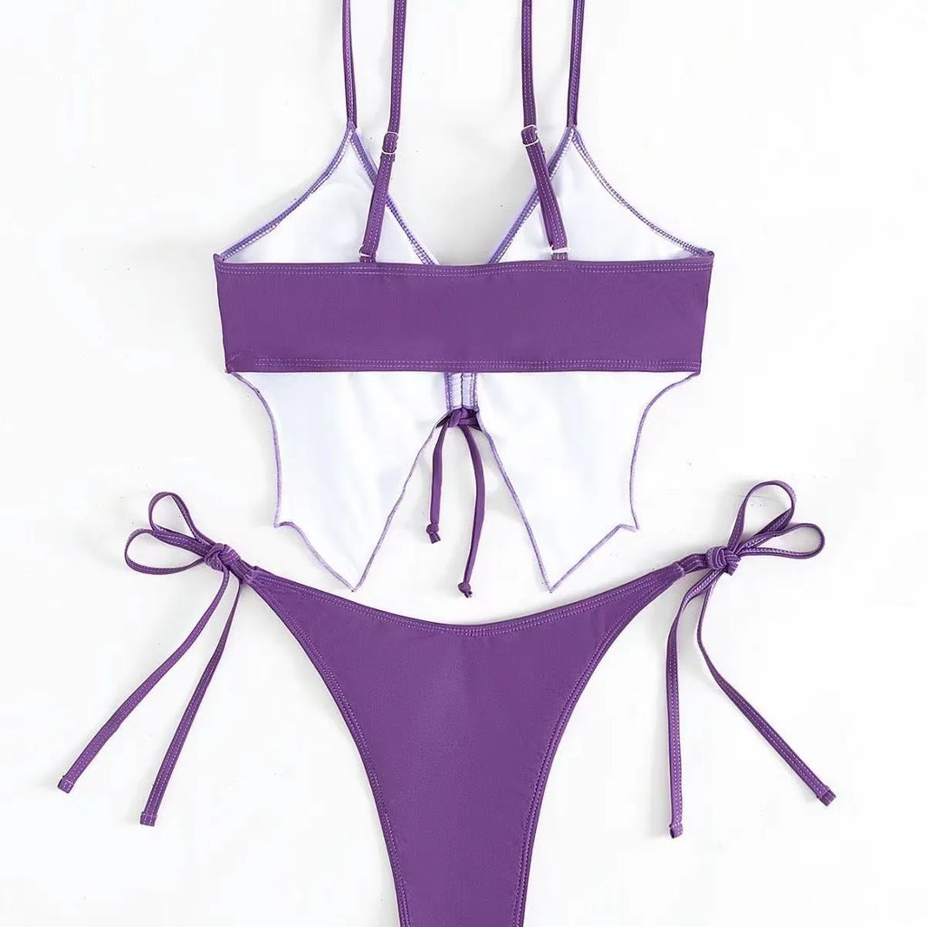 Women's purple bow style split bikini swimsuit with sleeveless top and briefs.