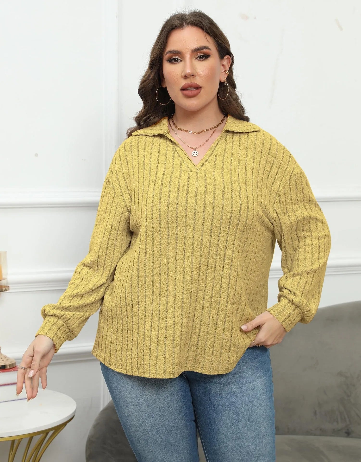 Plus size woman wearing a grey polo collar fleece pullover blouse with lantern sleeves.