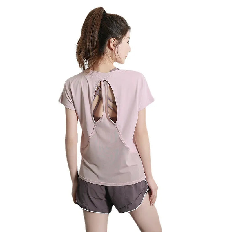 Women's short sleeve polyester fitness t-shirt in pink, shown for sports and gym wear.