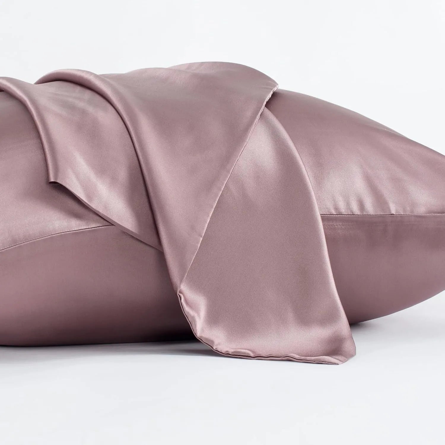 Dark grey silk pillowcase with envelope closure on a bed