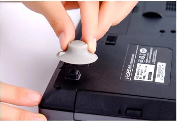 Four grey plastic laptop cooling pads: two large and two small, on a flat surface.