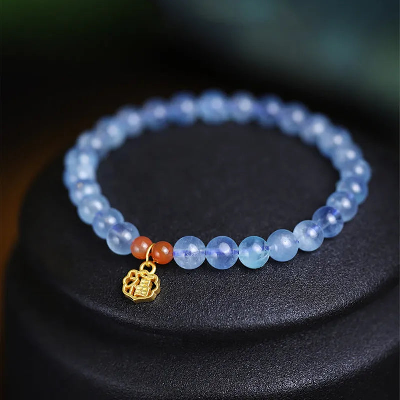 Aquamarine natural crystal bead bracelet with sequin charms on elastic cord
