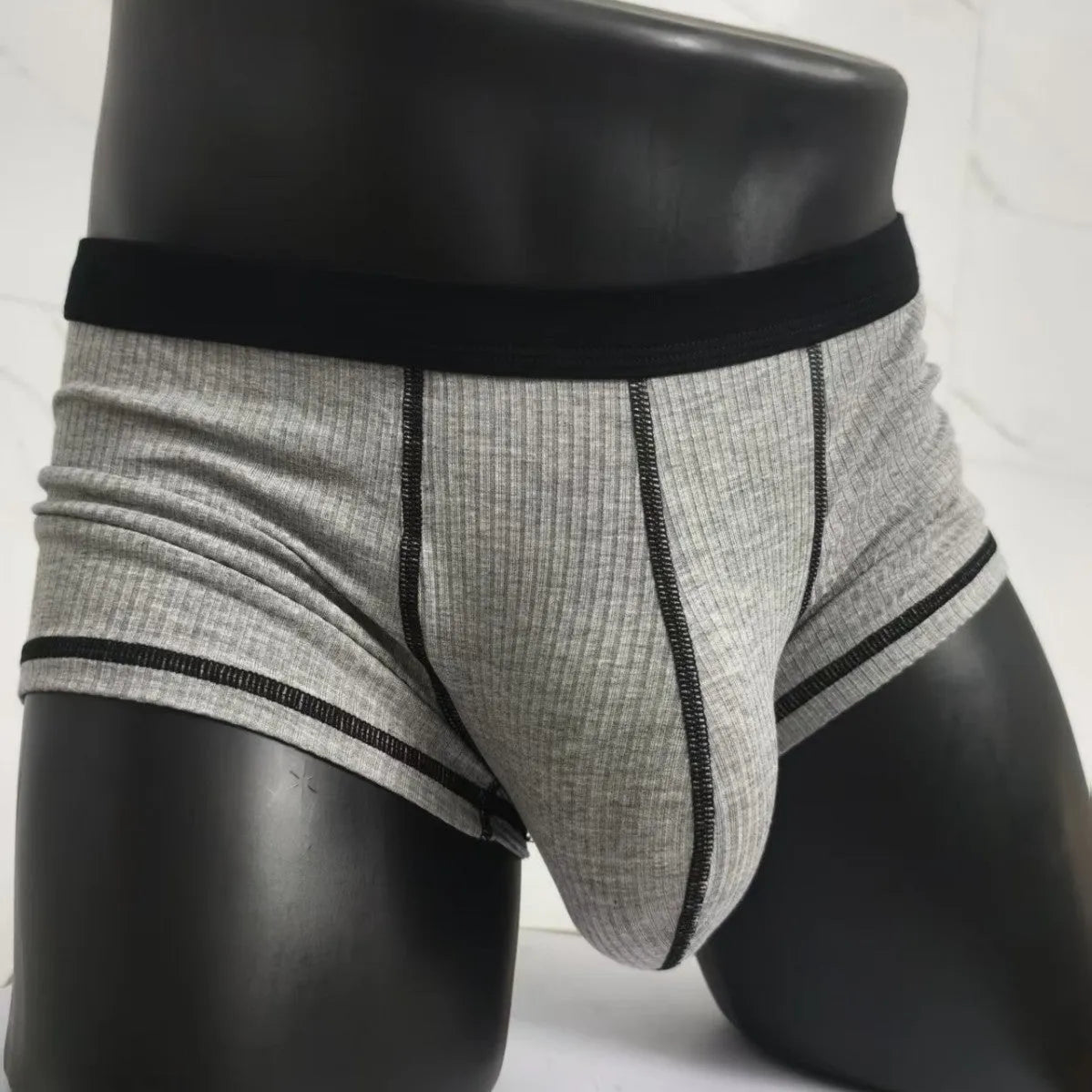 Men's thin fibre boxer shorts in army green, shown laid flat to display hip lift design.