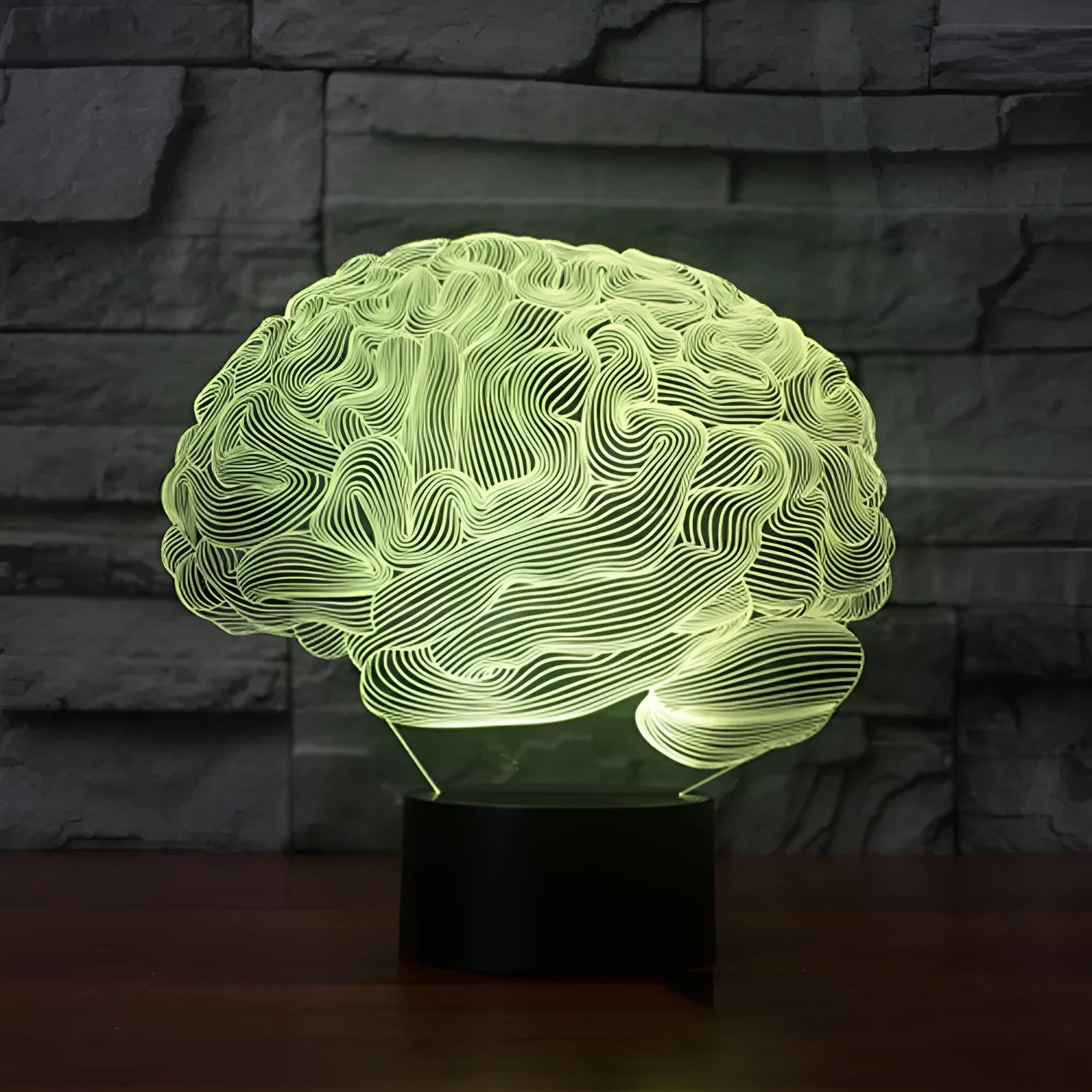 3D acrylic brain illusion LED desk lamp with remote control on a wooden table.