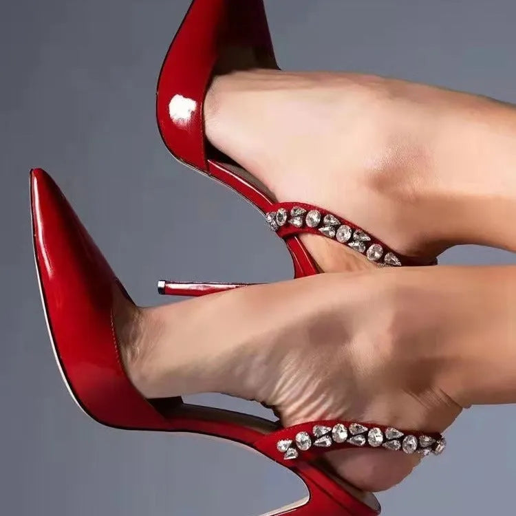 Women's black patent leather rhinestone high heel sandals with pointed toe and ankle strap.