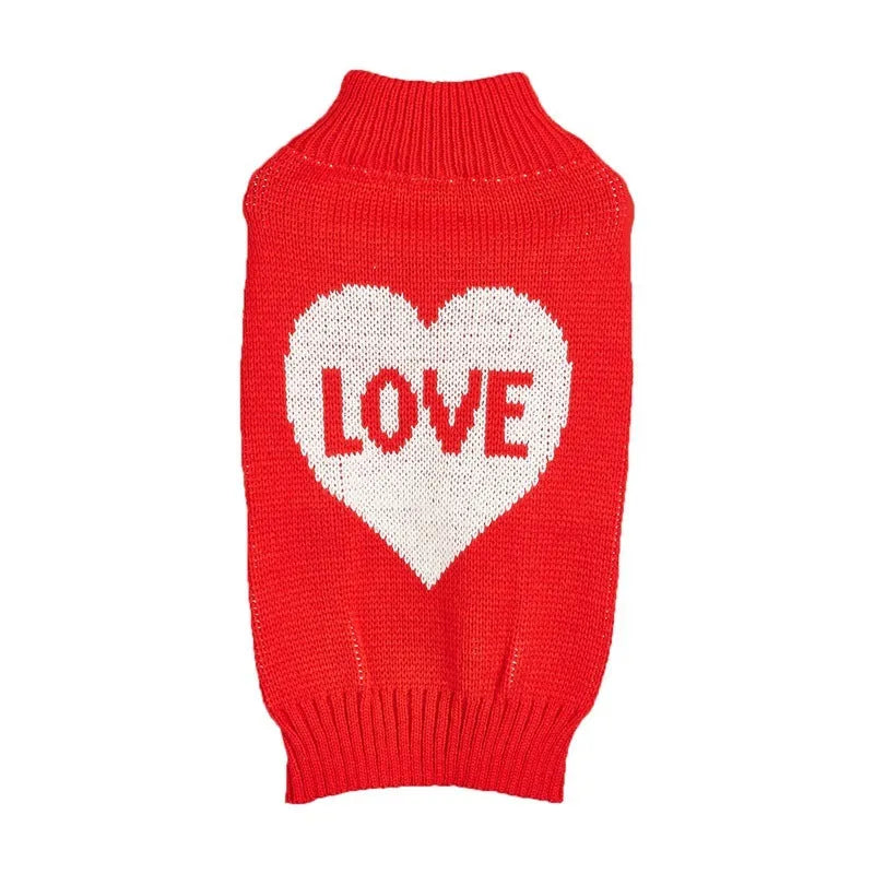 Red and pink dog sweater with love heart and bow design on a small dog.