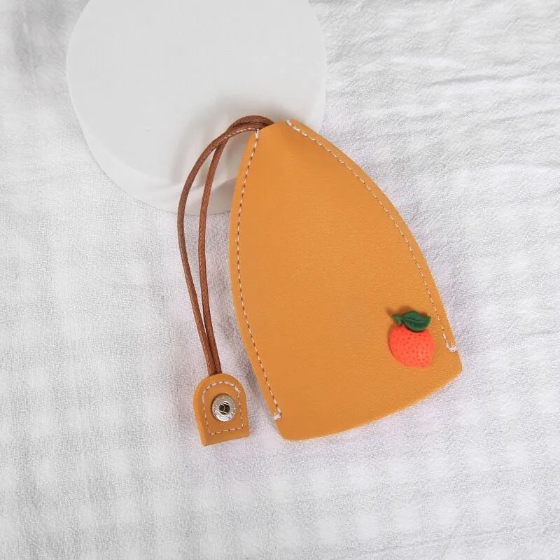 Cartoon pull-out key case in PU leather showing design options including resin fruit and big cartoon animal prints.