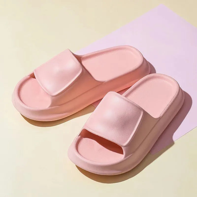 Pair of thick-soled EVA flip flop slippers in purple, showing deep sole profile.