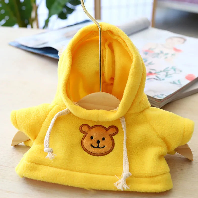 A selection of dog sweaters and hoodies in blue, pink, red, yellow, brown, and grey bear designs, shown in medium and large sizes.