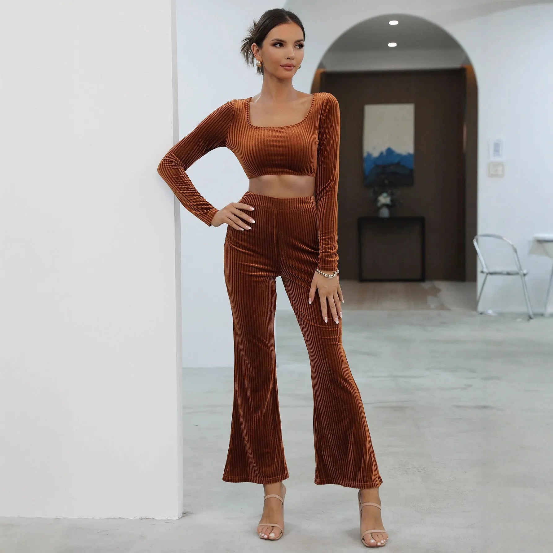 Women's caramel coloured long sleeve sweater and trousers loungewear set on a hanger.