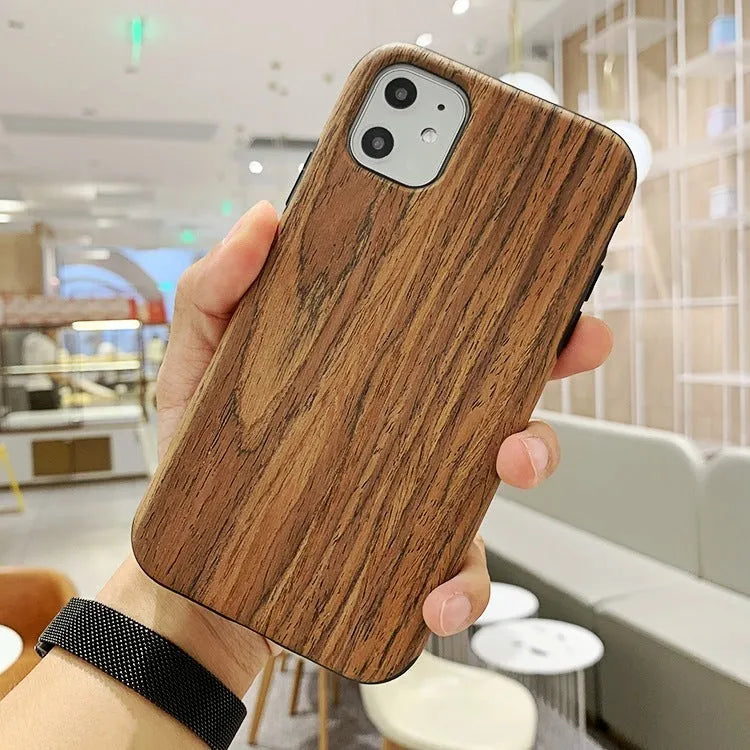 A slim wooden back cover case for an iPhone, showing the natural grain of rosewood or bamboo.