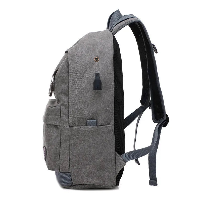 Canvas USB rechargeable backpack in grey showing front pocket and shoulder strap