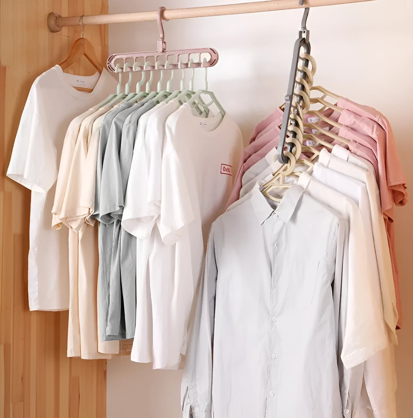 Plastic clothes hanger with rotating hook in assorted colours on white background
