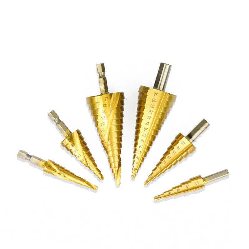 High speed steel cone step drill bits and a centre punch arranged on a workshop bench.