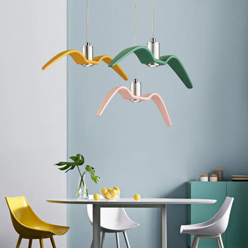 Nordic style ceiling chandelier with macaron colour options shown in a dining room setting.